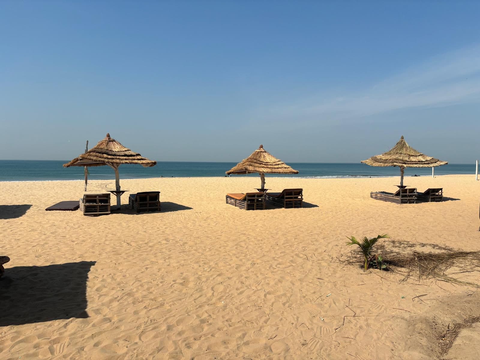 Solstolar och parasoll på stranden i Gambia
